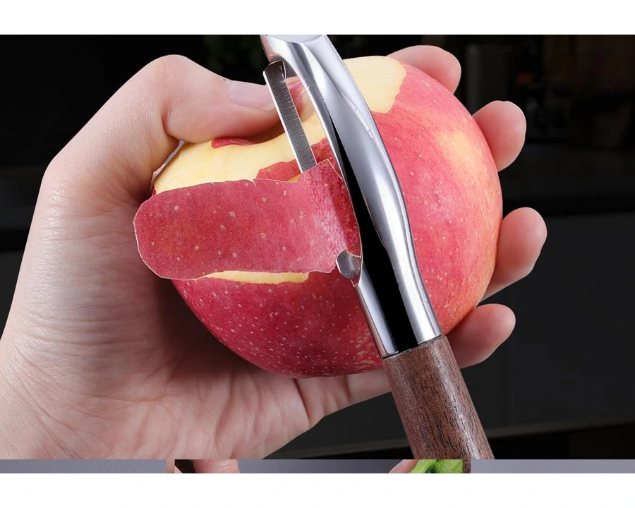 I-shape wood-handle peeler making a long peeling stroke on an apple